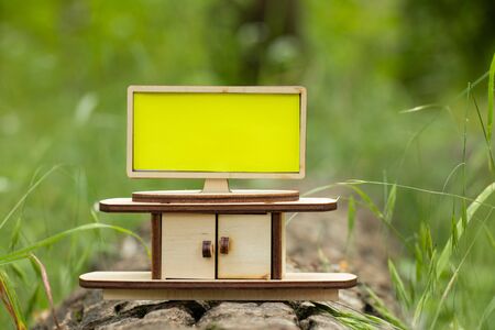 tv and a small children's wooden bedside table stand in the forest in the sun with an empty place for textの写真素材