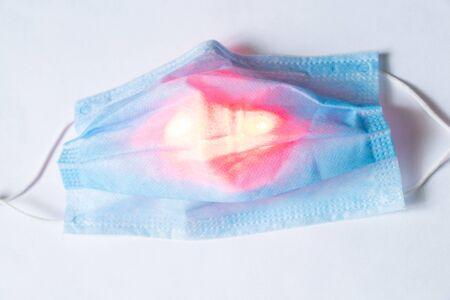 medical mask with a red light in the middle