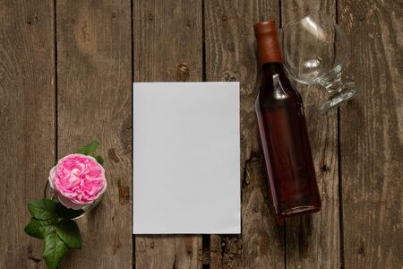 bottle of whiskey old wine glass and empty white sheet for text on a tableの写真素材
