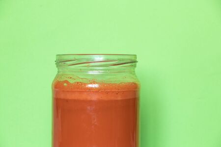 freshly squeezed carrot juice in a glass jarの写真素材
