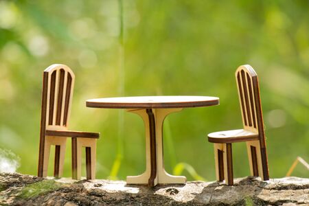 table and chair children's toy made of wood stand outdoors in the forestの写真素材