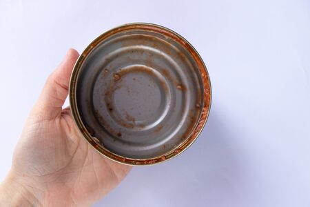 dirty tin can after eaten sprats on a white
