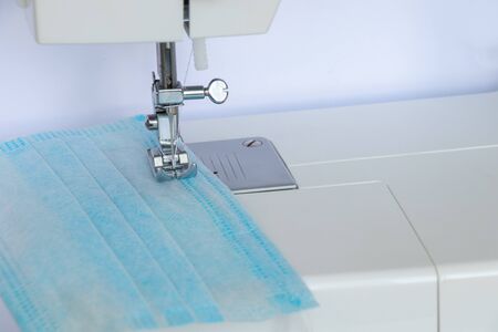new sewing machine sews a medical mask during a pandemicの写真素材