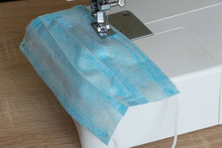 new sewing machine sews a medical mask during a pandemicの写真素材