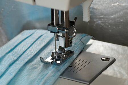 new sewing machine sews a medical mask during a pandemicの写真素材