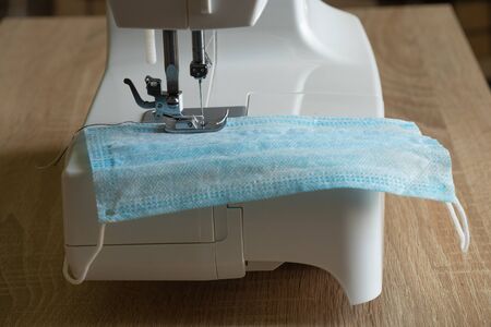 new sewing machine sews a medical mask during a pandemicの写真素材