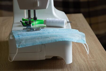 new sewing machine sews a medical mask during a pandemicの写真素材