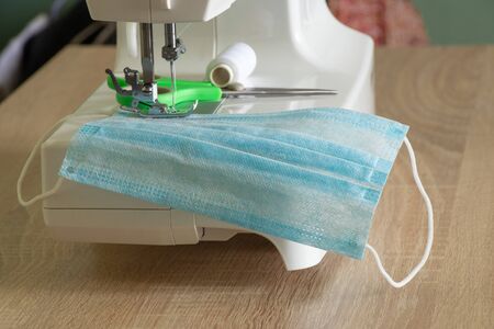 new sewing machine sews a medical mask during a pandemicの写真素材