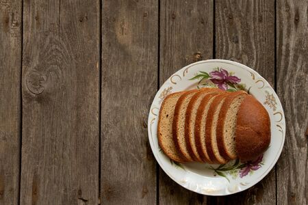 black sliced bread on an wooden tableの写真素材