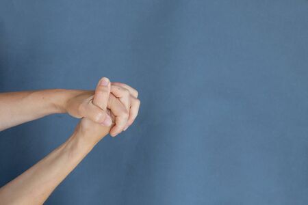 young female hand on gray backgroundの写真素材