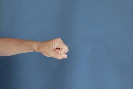 young female hand on gray background