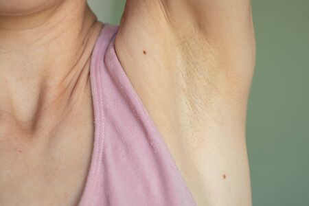 armpit of a young girl with hairs on an isolated backgroundの写真素材