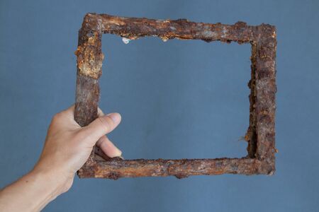 old rusty frame in a girl's hand on a grayの写真素材