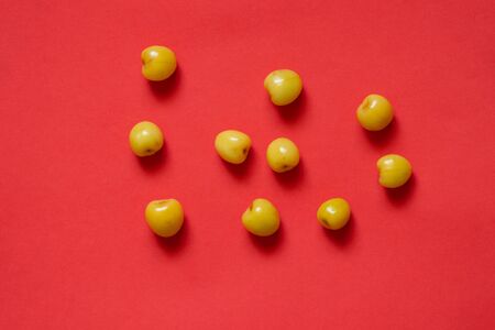 yellow cherries scattered on a colored background