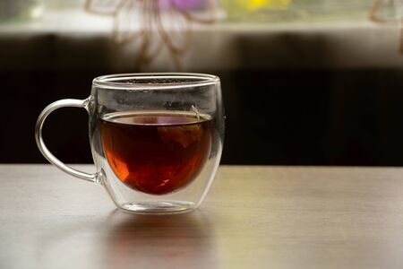 glass transparent cup with herbal tea on a tableの写真素材