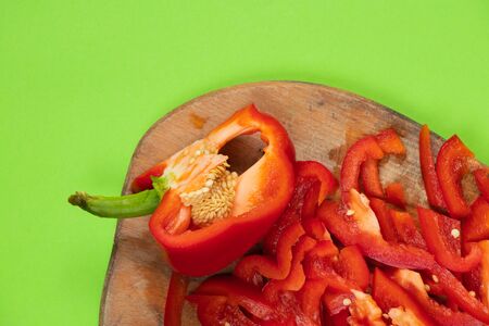 chopped sweet red pepper lies on a wooden boardの写真素材