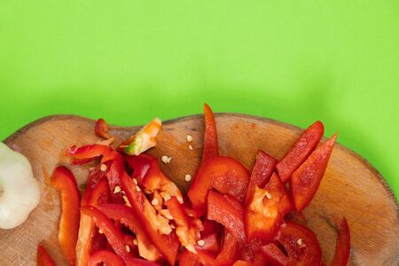 chopped sweet red pepper lies on a wooden boardの写真素材