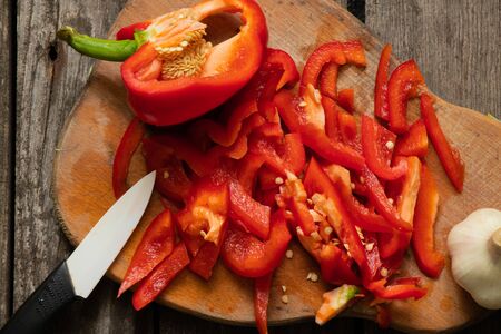 chopped sweet red pepper lies on a wooden board