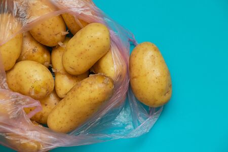 a young potato in a bag on a table bought at a bazaarの写真素材