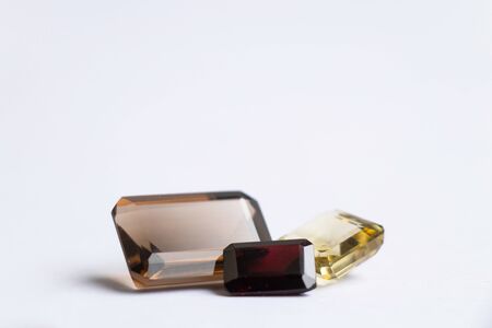 faceted precious stones of various shapes and sizes on a white background topaz aquamarineの写真素材