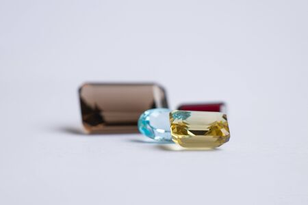 faceted precious stones of various shapes and sizes on a white background topaz aquamarineの写真素材