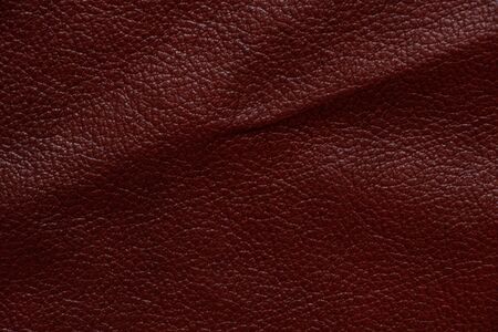 dark red genuine leather as a close up backgroundの写真素材