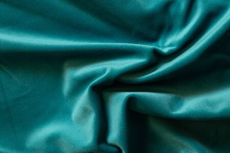 plain dark blue crumpled fabric as a background close upの写真素材