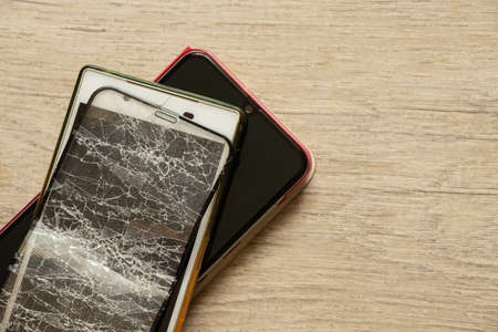 mobile phone and broken tempered glass on an isolated background, glass replacementの写真素材