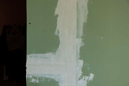 plasterboard green on the wall, room repairの写真素材