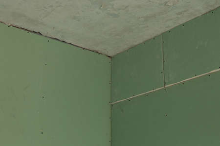 plasterboard green on the wall, room repairの写真素材