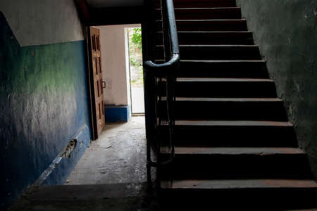 dark staircase inside with a staircase to the second floor in an old house in Ukraine in the citiesの写真素材
