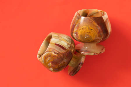 a glass of onyx stone on a colored background close upの写真素材
