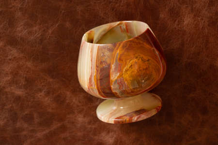 a glass of onyx stone on a colored background close upの写真素材