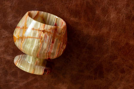 a glass of onyx stone on a colored background close upの写真素材