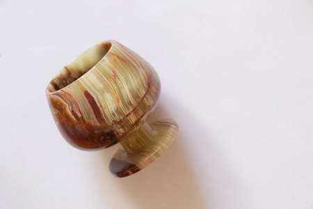 a glass of onyx stone on a colored background close upの写真素材