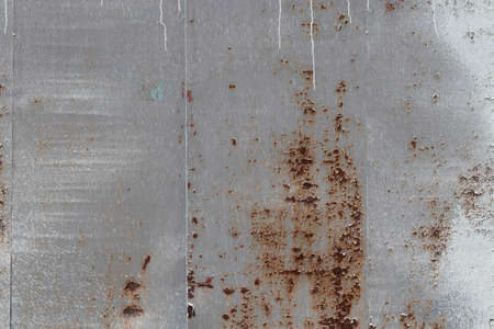 old rusty wall in white paint as a backgroundの写真素材