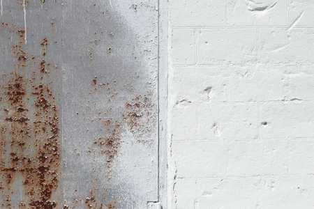 old rusty wall in white paint as a backgroundの写真素材