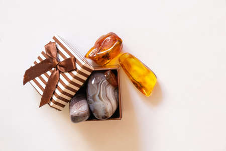 gemstones amber agate in a gift box on a white backgroundの写真素材