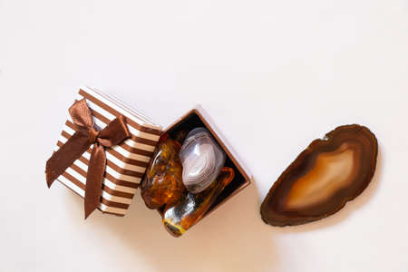 gemstones amber agate in a gift box on a white backgroundの写真素材