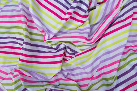 multicolored striped fabric crumpled as background close-upの写真素材