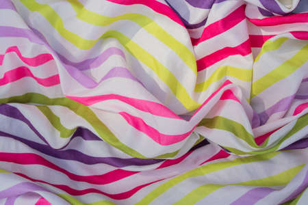 multicolored striped fabric crumpled as background close-upの写真素材