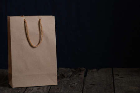 brown paper bag on dark background close upの写真素材