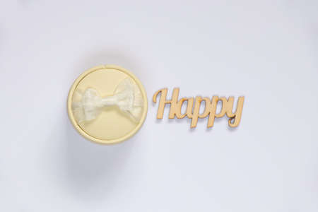 gift box with a bow on a white background for a ring and the word happy in english from woodの写真素材