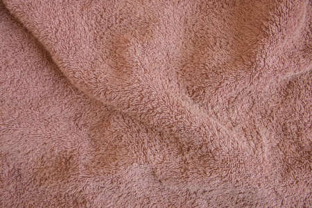 brown terry towel for the bathroom as a background close-upの写真素材