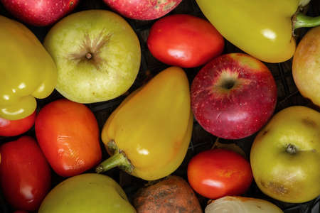 a box with homemade vegetables and fruits apples potatoes cabbage pepper at home in the kitchen