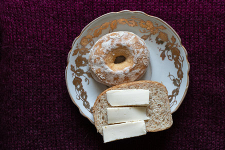 gingerbread and a sandwich with cheese lie on a plate on a dark background for lunch for tea