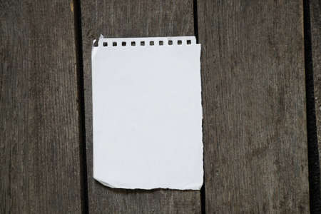 white blank sheet with notepad lies on a wooden tableの写真素材