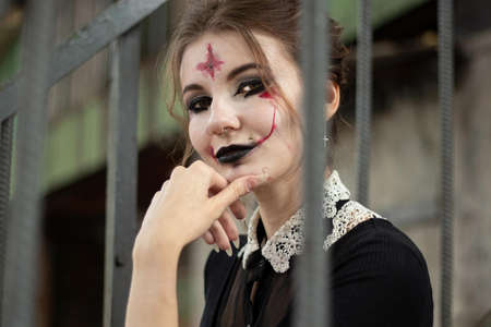 portrait of a girl with makeup for halloween carried bars on the street, people for halloweenの写真素材