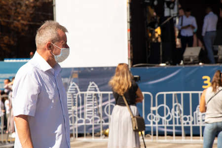 Ukraine Dnipro 10 21 2020 - a man in a medetsyn mask walks through the city center, people are in quarantineのeditorial素材