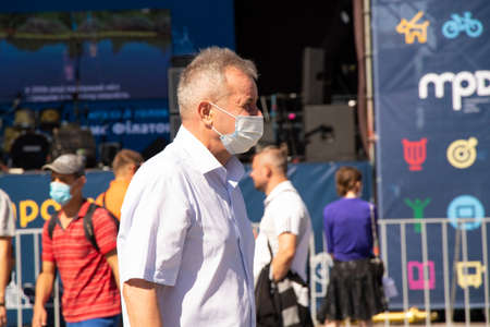 Ukraine Dnipro 10 21 2020 - a man in a medetsyn mask walks through the city center, people are in quarantineのeditorial素材
